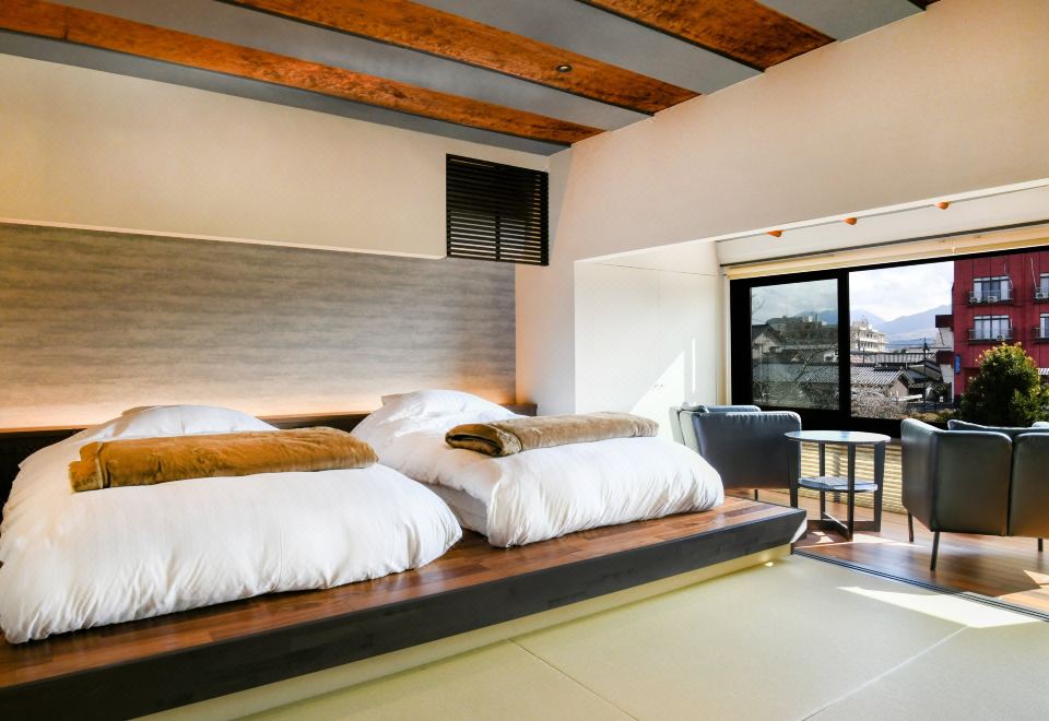 A Japanese room with twin beds and a sitting area.