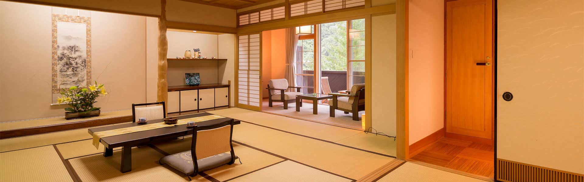 Hotel Hodaka with a traditional tatami room opening toward garden greenery.