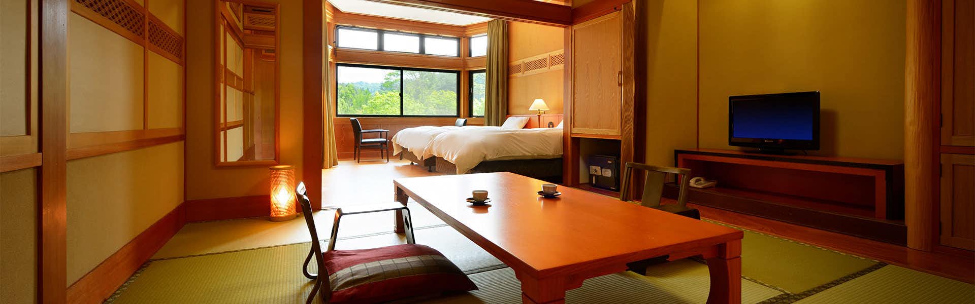 Yukaen, Mountain God Onsen with a candlelit tatami room with low table and window seating.