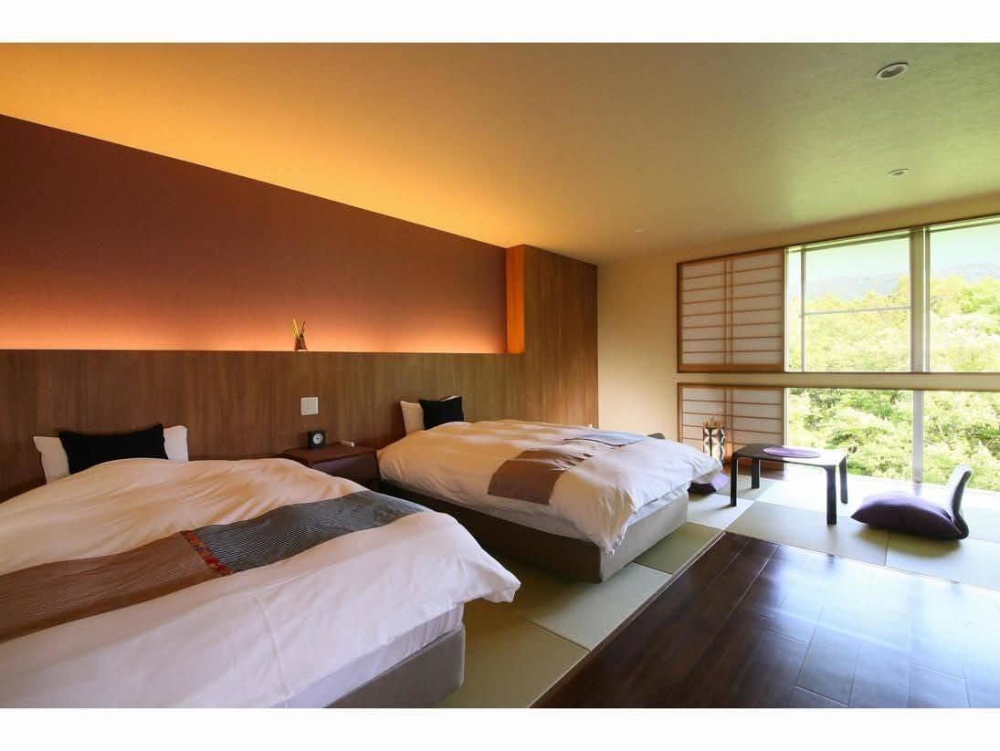 Hotel Miyama with a modern twin bedroom with garden-facing windows.