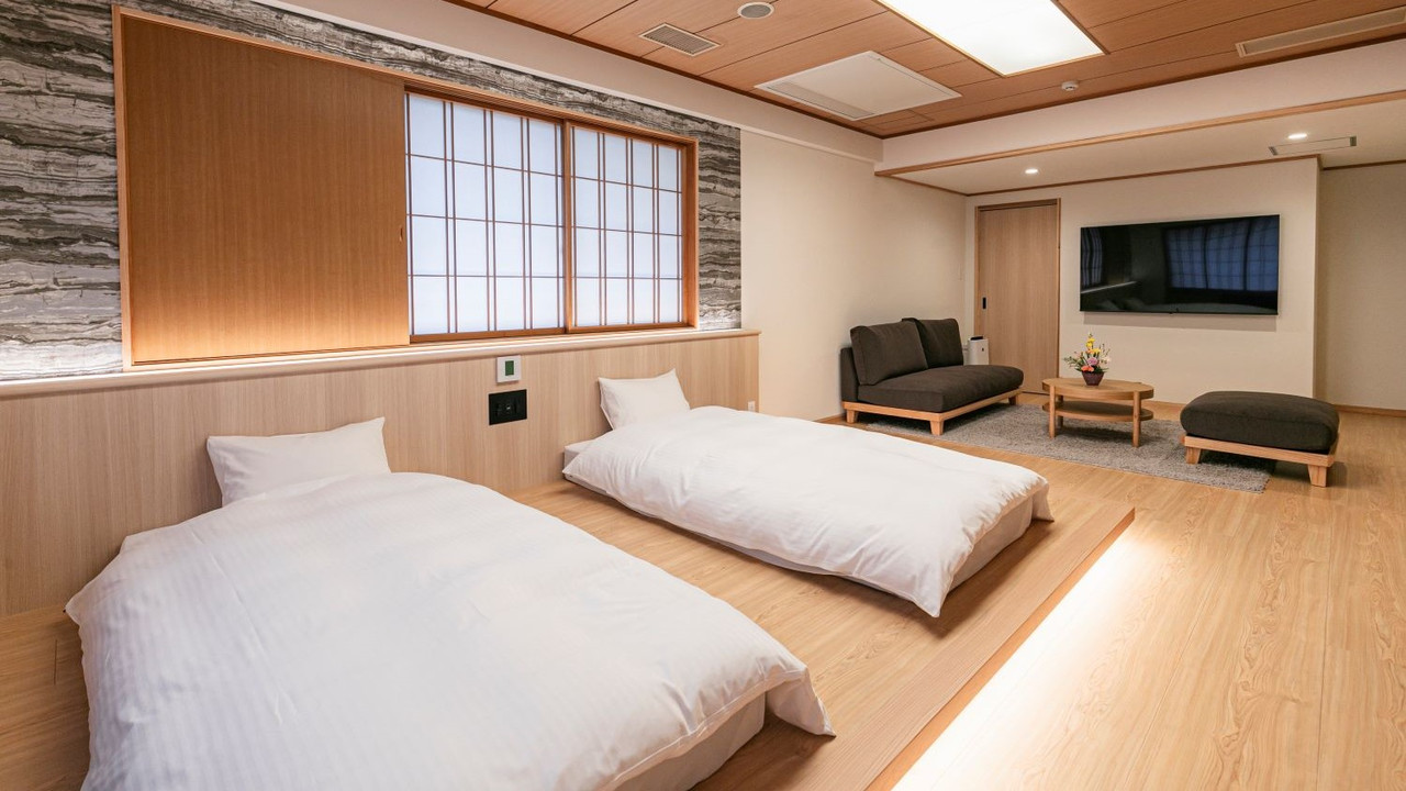 A simple Japanese-style sleeping area is arranged with low furnishings.