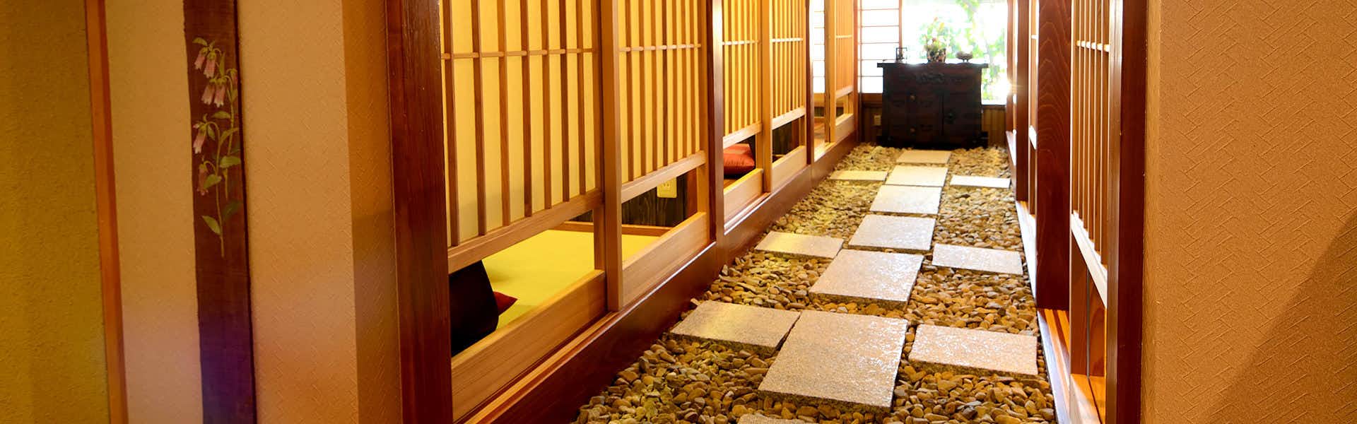Oyado Hanamizuki with a patterned tile corridor leading through the inn.