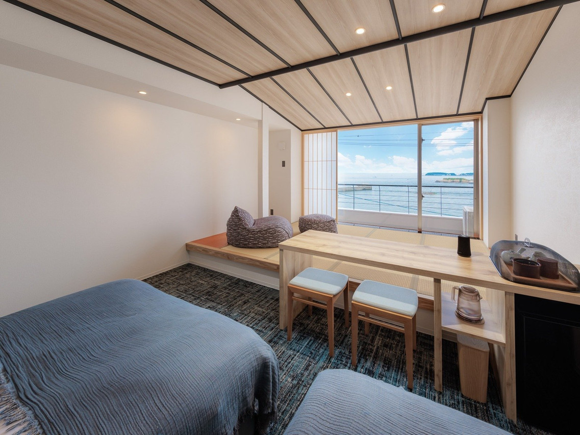 A bright sitting area opens to a coastal view.