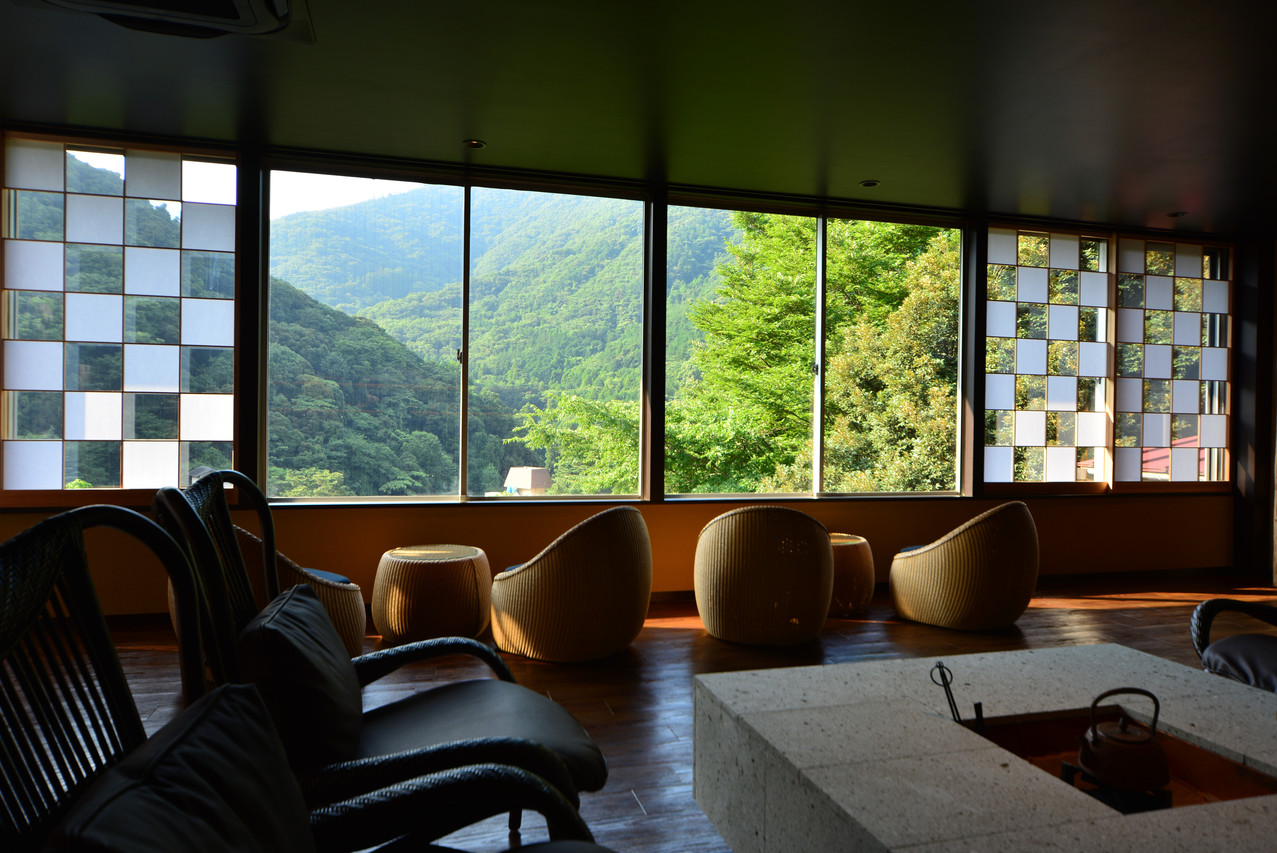 A dining area overlooking green hills.