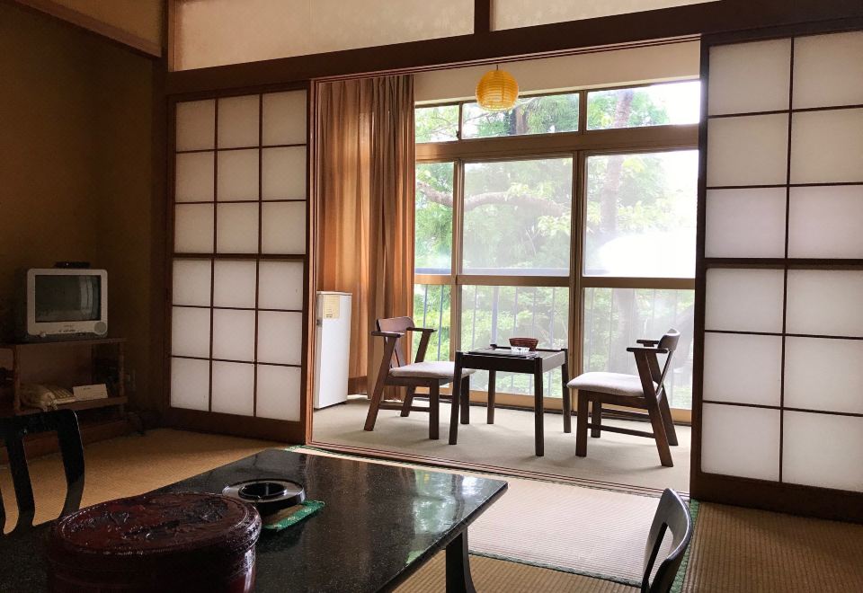 Japanese-style guest room with a sitting area and shoji screens.