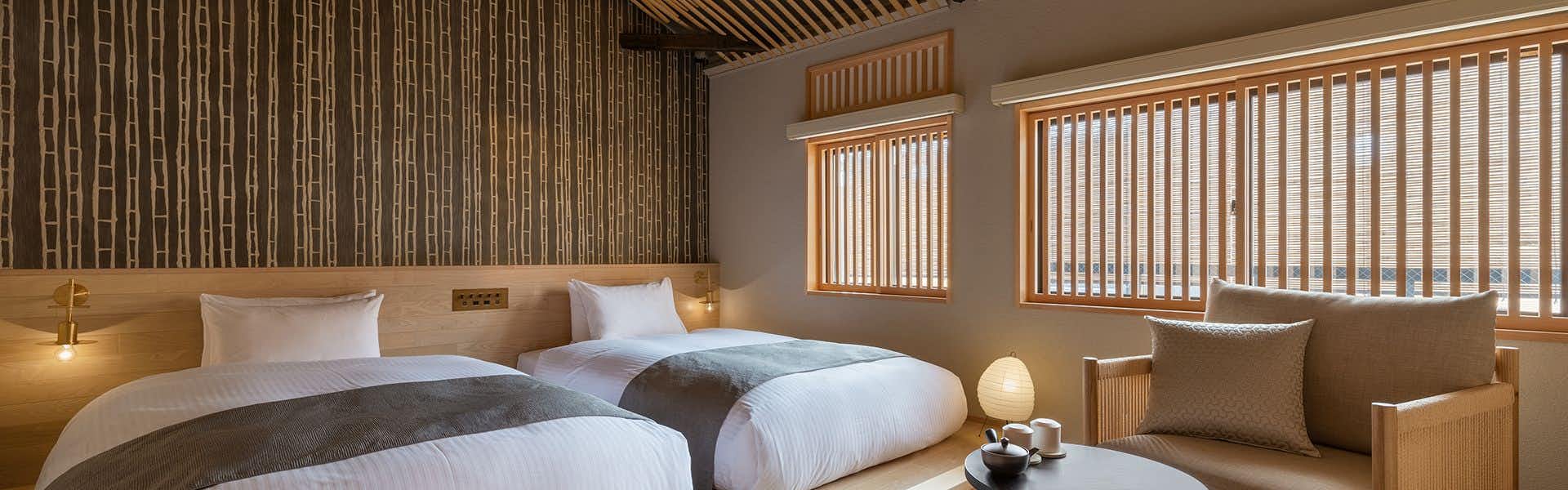 Nazuna Kyoto Tsubaki Street with a serene twin bedroom with timber slats and pale furnishings.