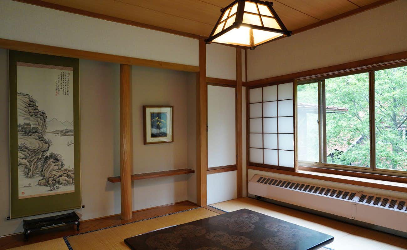 Kamikochi Yama no Hidaya with a simple tatami room overlooking leafy woodland.