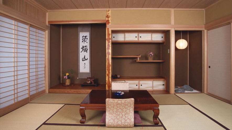 A tatami room with a low table and decorative alcove.