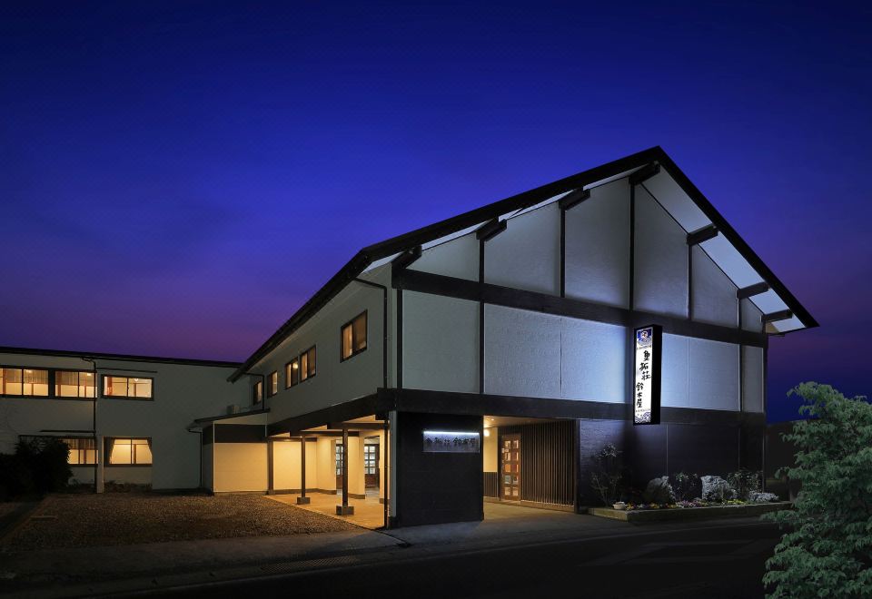 A traditional building illuminated at dusk.