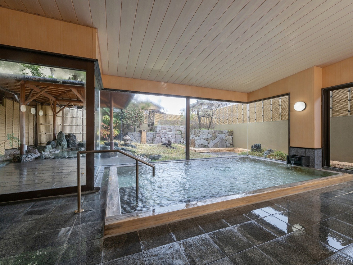 A wide indoor pool reflects the surrounding windows.