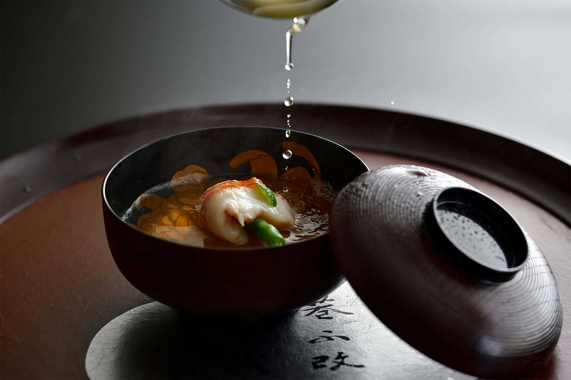 Touryu-kan with clear soup served inside a dark lacquered bowl.