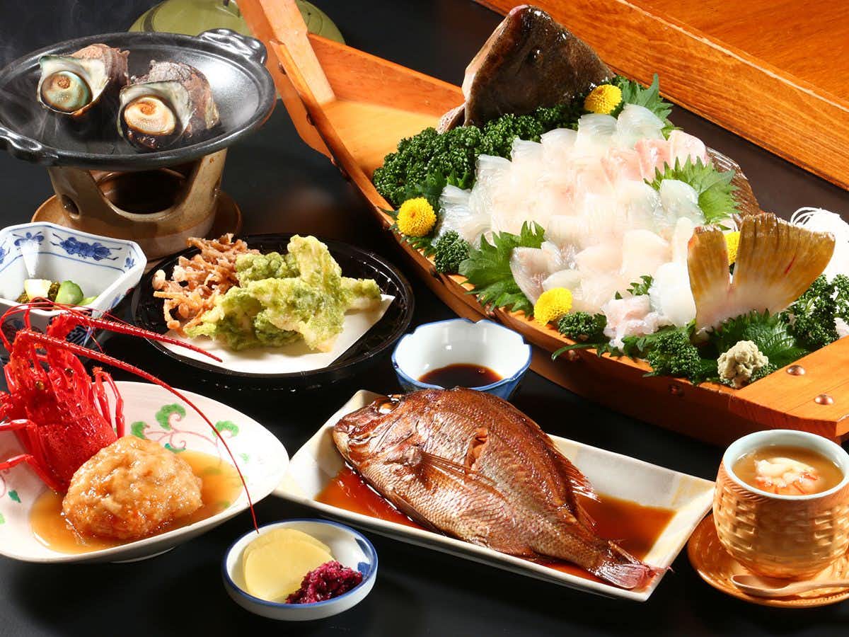 Ryokan Hisada with a seafood feast centered on sashimi and grilled fish.