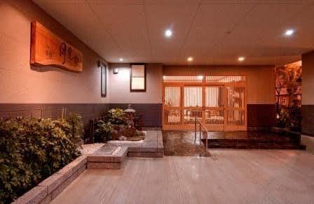 Ryokan Tsukimiso with this scene, where a compact indoor bathing area sits beyond softly lit timber screens.