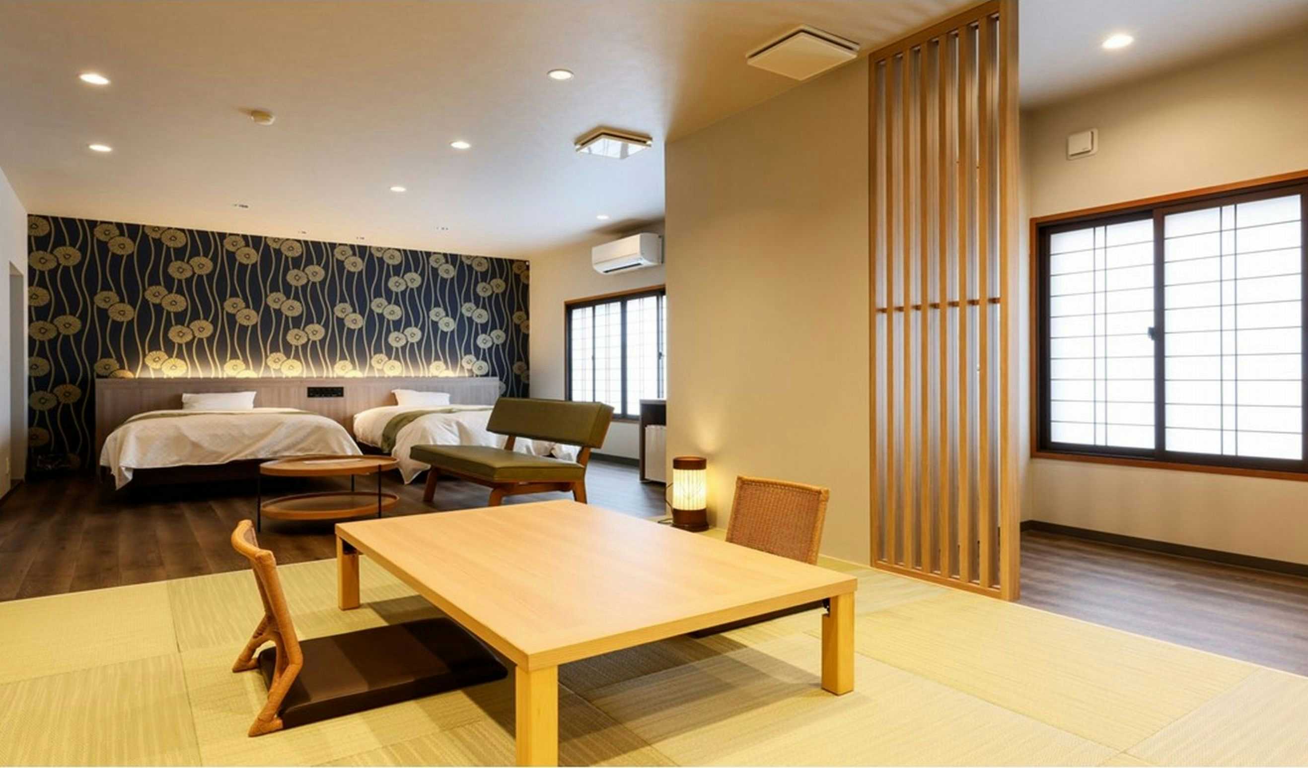 Kinosaki Onsen Ryokan Oyado Hakusan with a modern tatami room with twin beds and a low timber table.