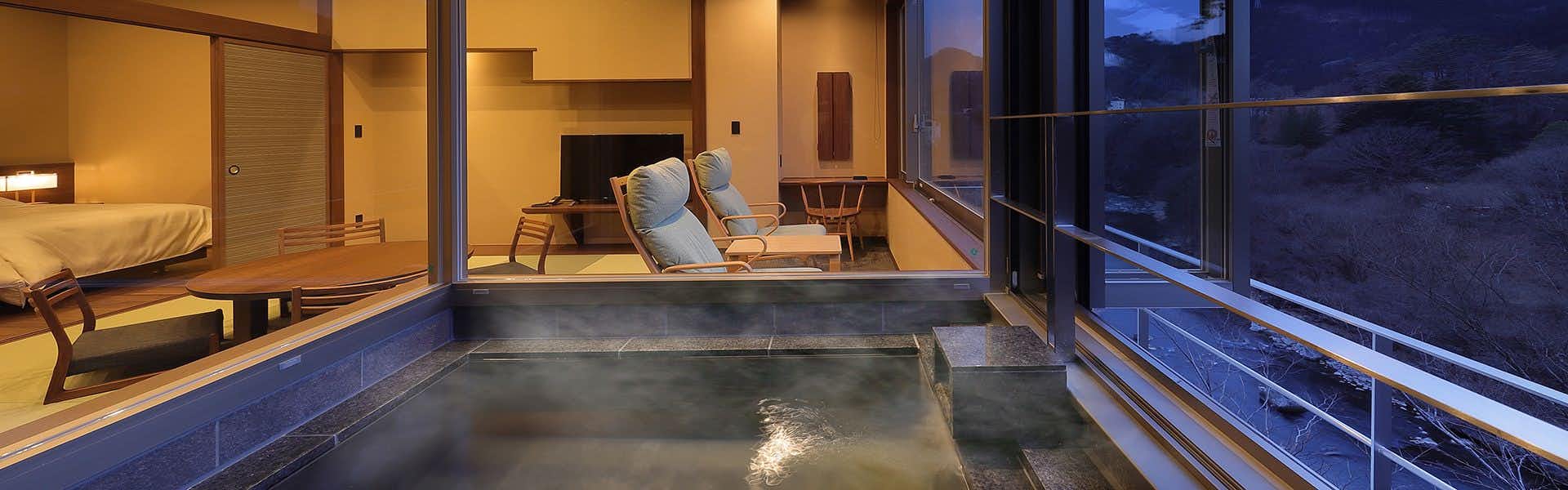 Inn of Serenity and Sincerity, Nanae Yae with a guest room with private bath and woodland windows.
