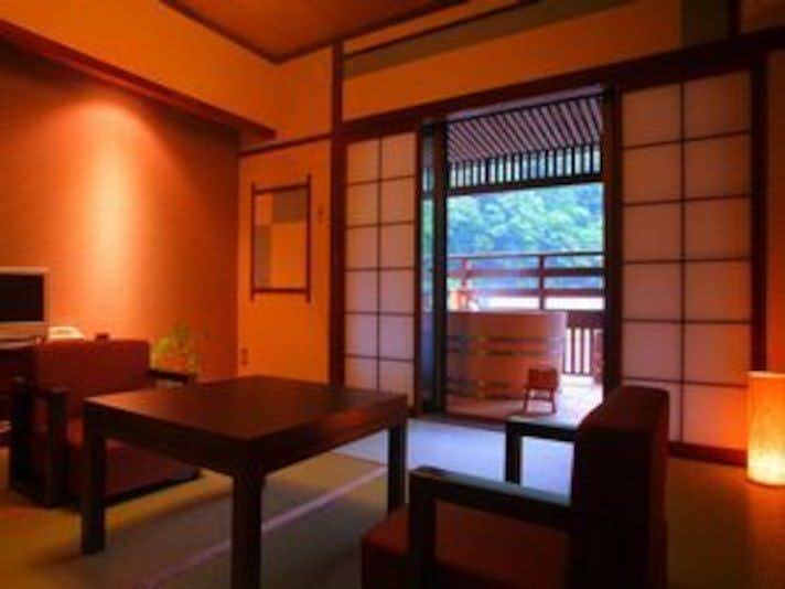 Kaido Roman On-yado Tsutaya with a warm tatami room opening onto a balcony.
