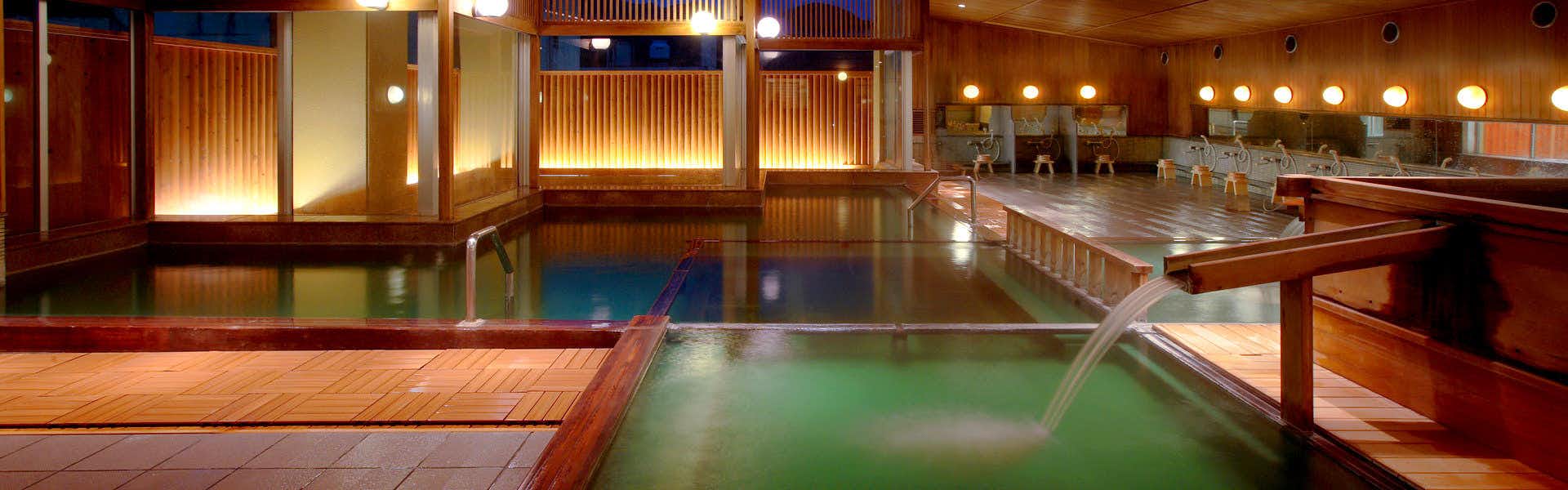 Naruko Hotel with a spacious indoor mineral bath with green-tinted water.