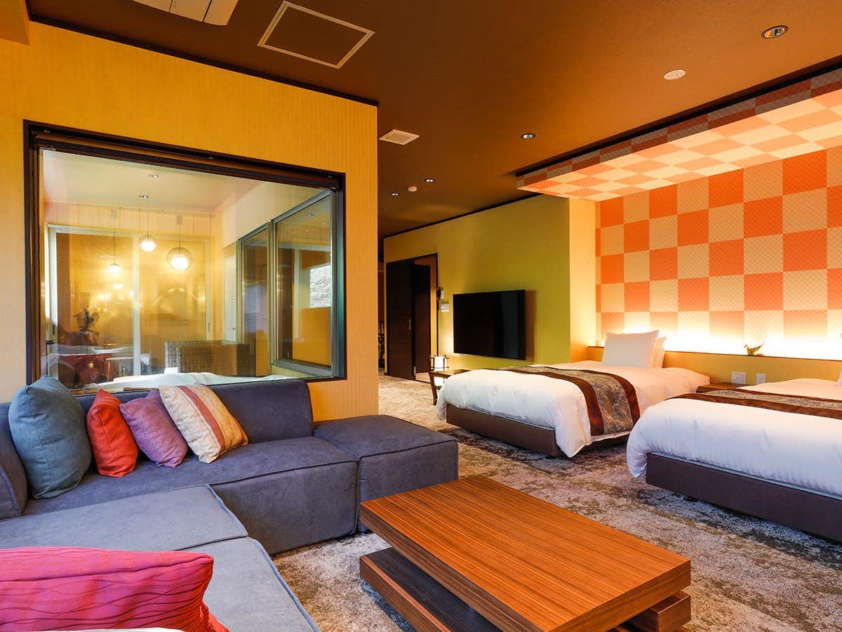 Kurama Onsen Masagokan with this scene, where a broad sofa and low timber table furnish a modern Japanese-western suite.