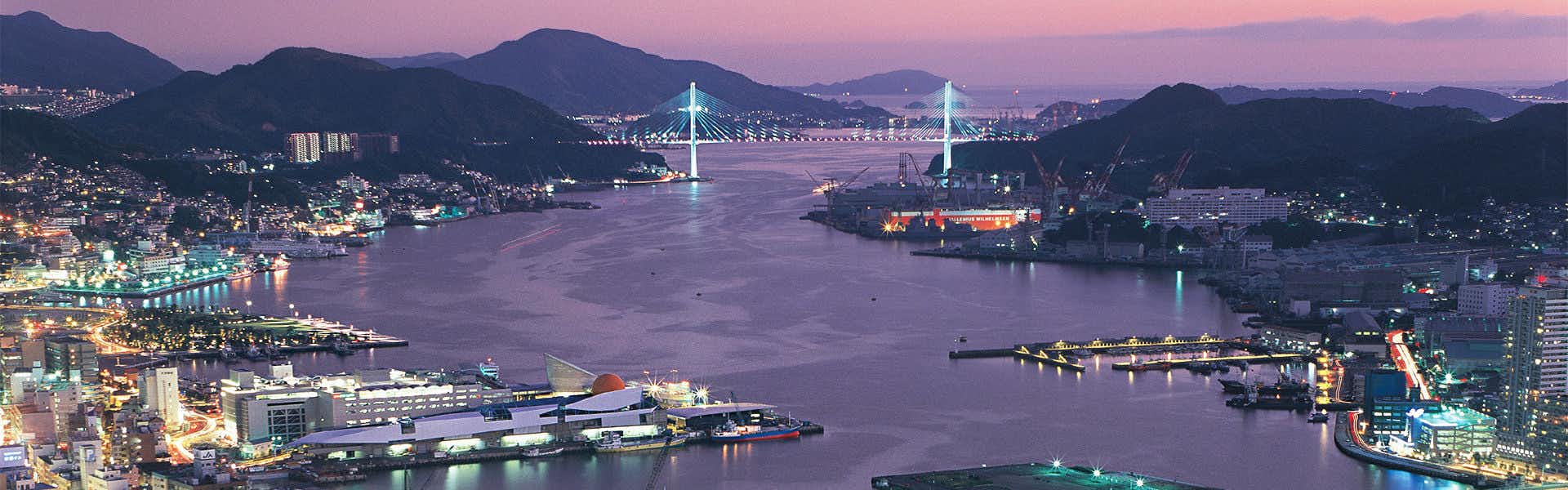 Nisshokan Bettei Koyotei with a panoramic night view of Nagasaki city lights and harbor.