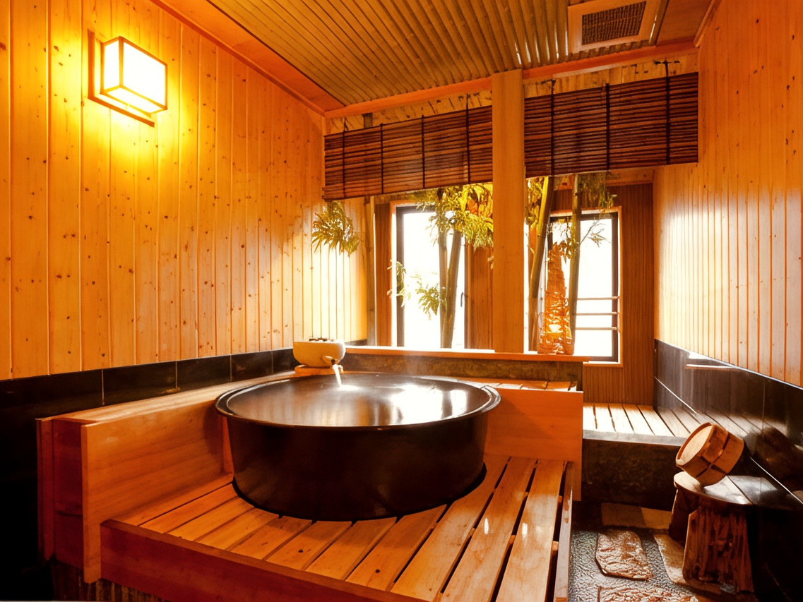 Wood-paneled bath with a round tub.