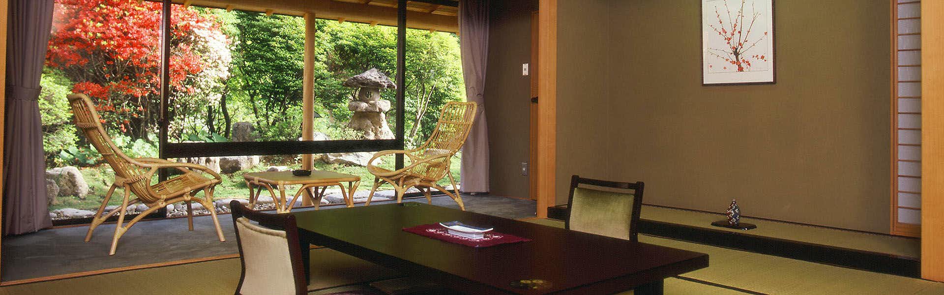 Morioka Tsunagi Onsen Shikitei with a traditional tatami room overlooking a red autumn garden.