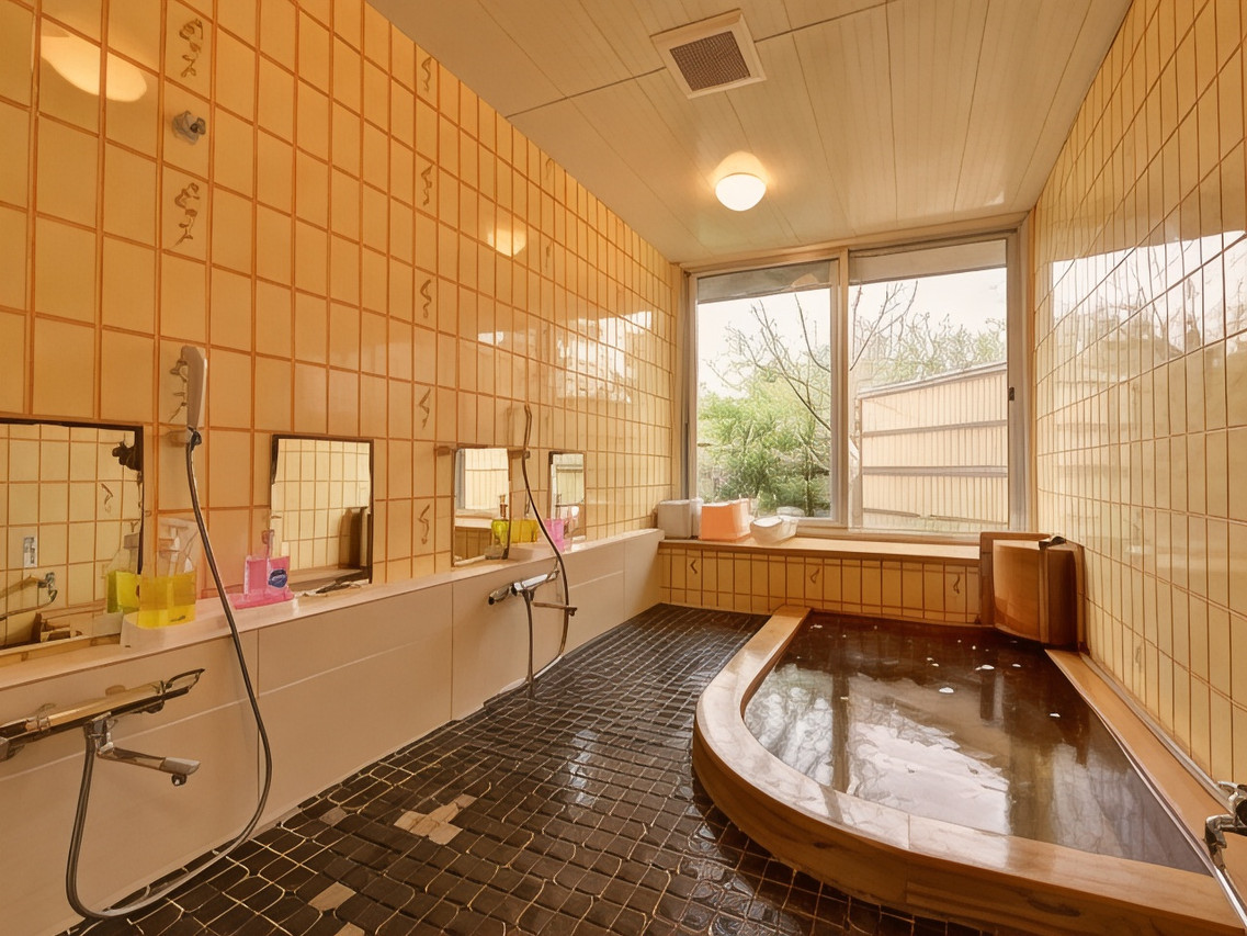 A tiled bath combines a wooden tub with garden views.