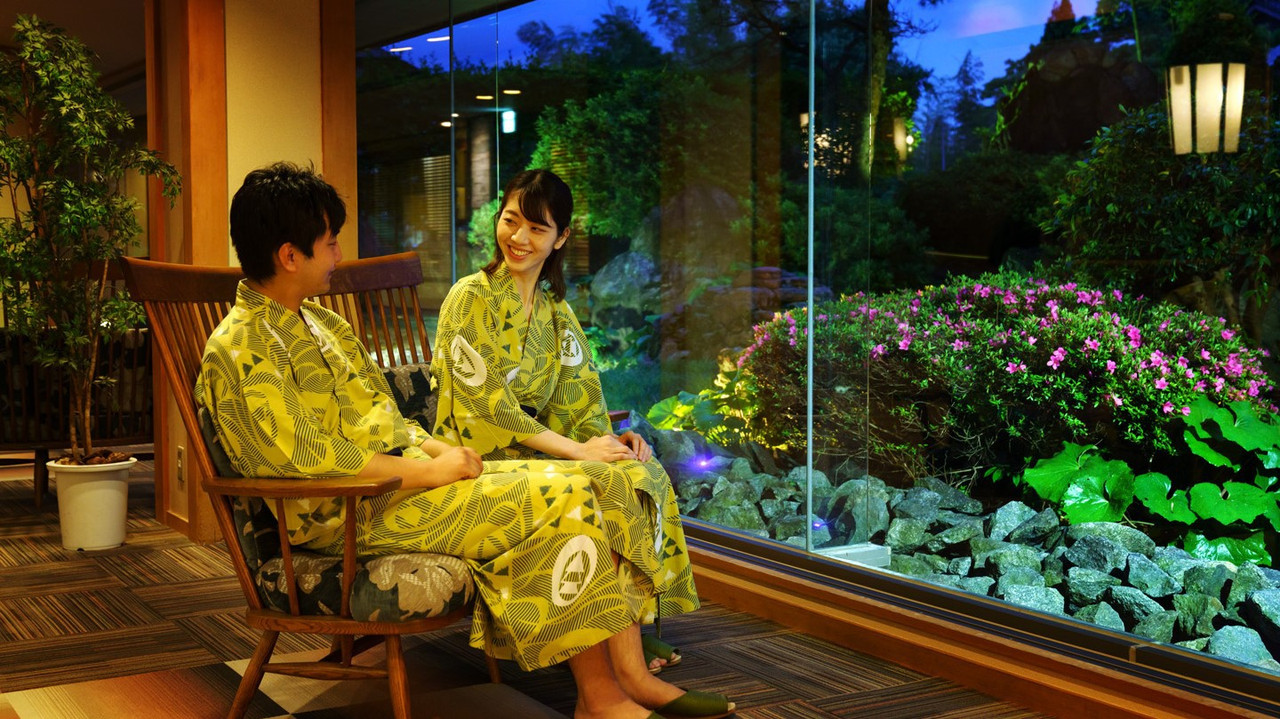 Guest room seating beside a garden.