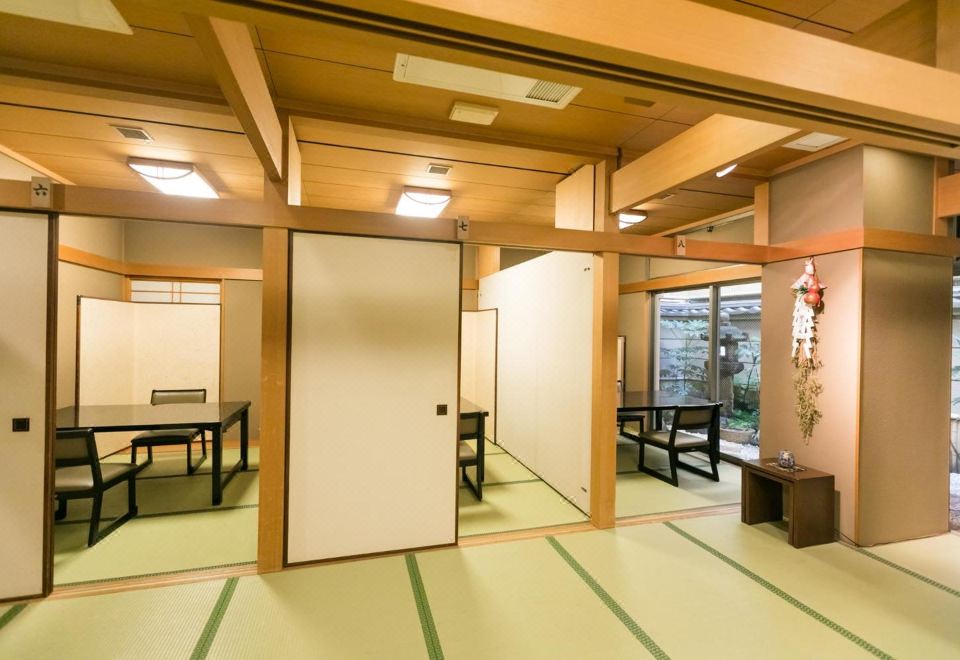 A traditional room opens across tatami flooring with low seating.