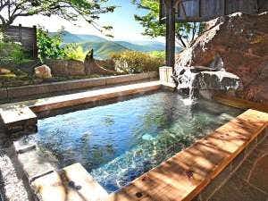 Relaxing Inn Sawemon with an outdoor timber-edged bath overlooking distant mountains.
