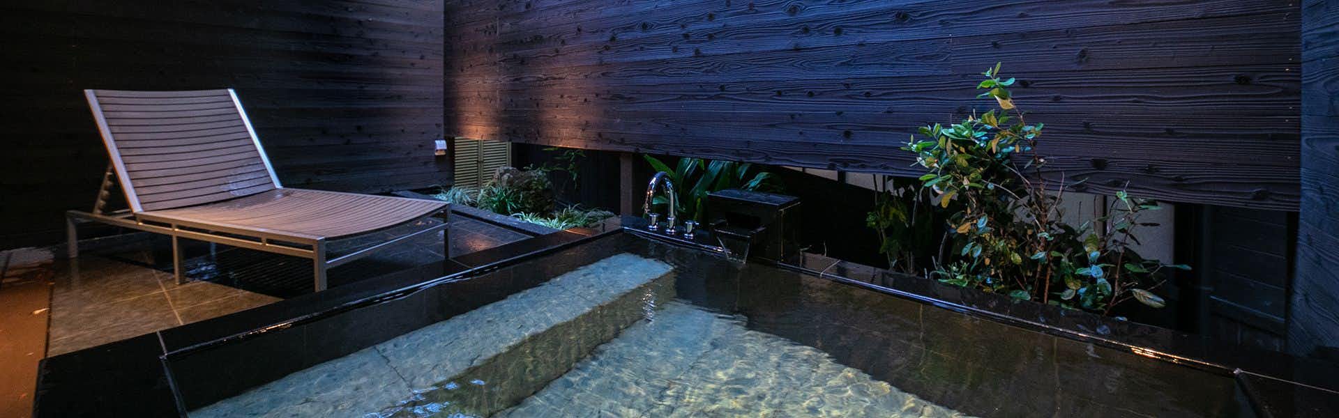 Yutaka no Go Saigakukan with a private outdoor bath overlooking the mountain landscape.