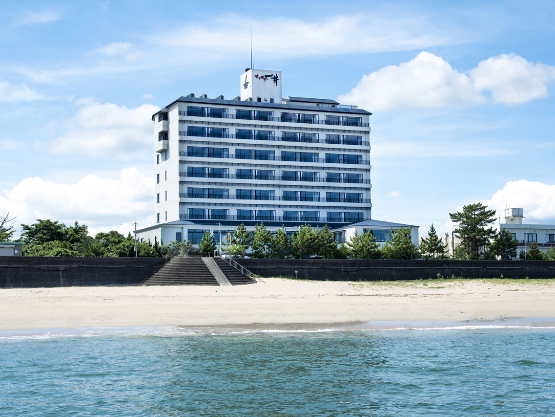 White building beside the water.