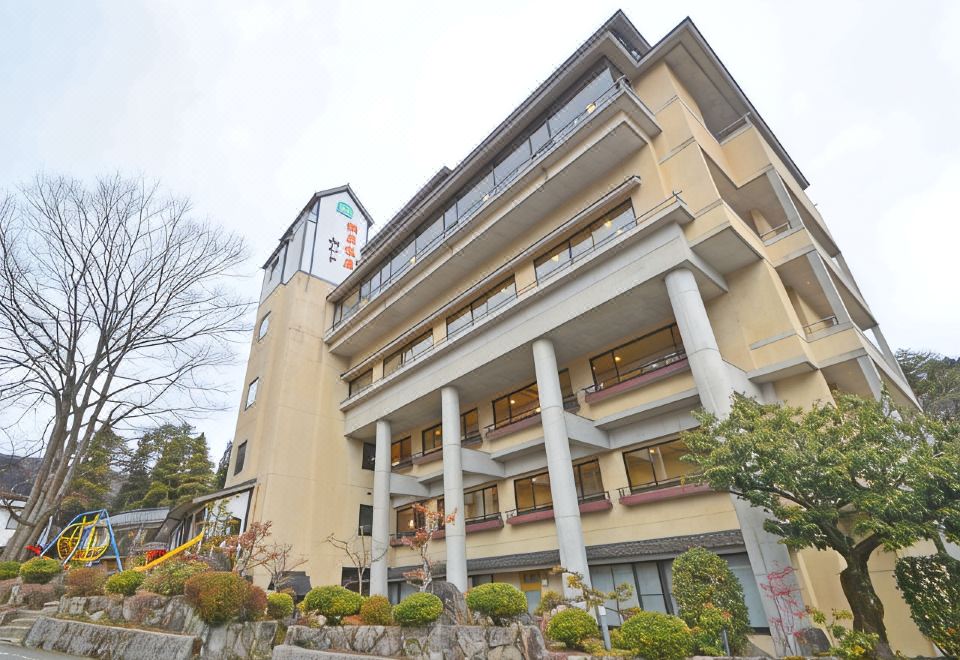 A multi-story inn exterior among trees.