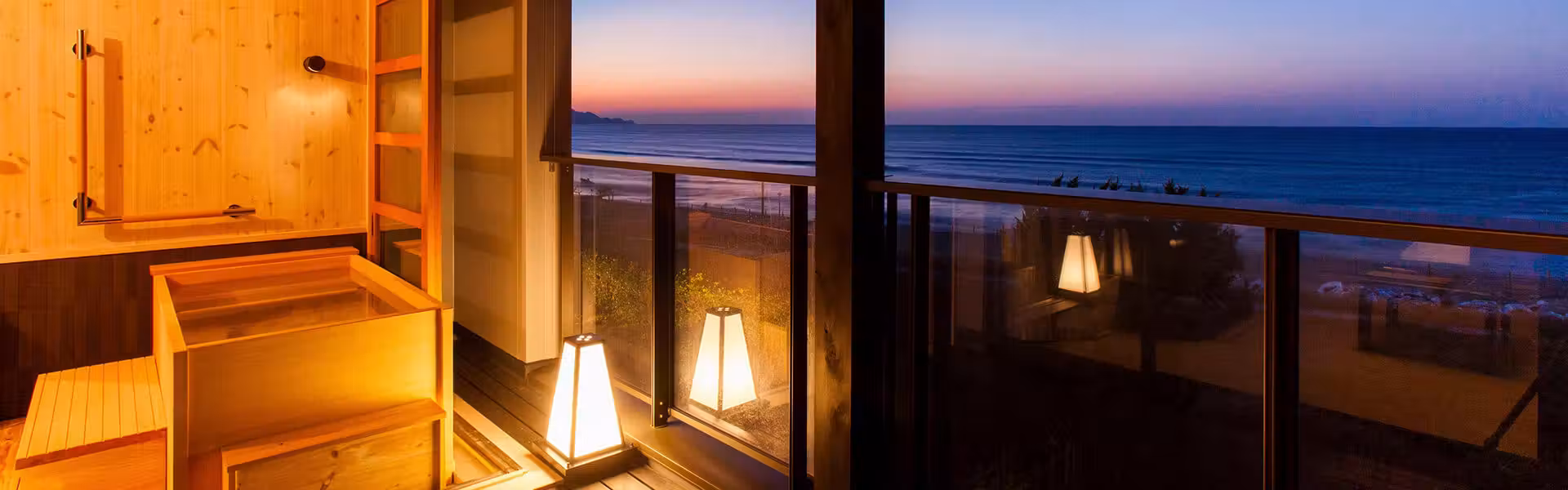 Yusai Resort Hibiki with this scene, where a guest-room terrace and bath look across the Sea of Japan at sunset.