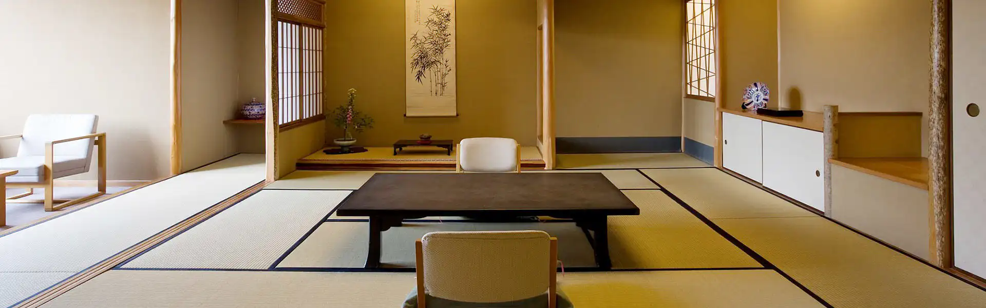 Miyajima Grand Hotel Arimoto with this scene, where its quiet tatami guest room has an alcove, low table and shoji screens.