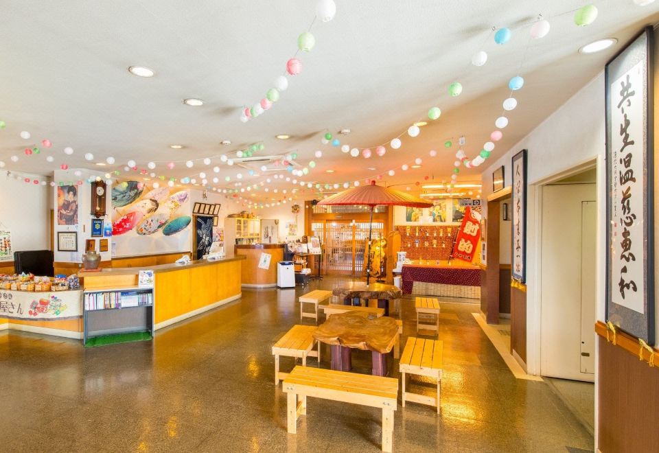 An indoor reception and seating area decorated with hanging lights.