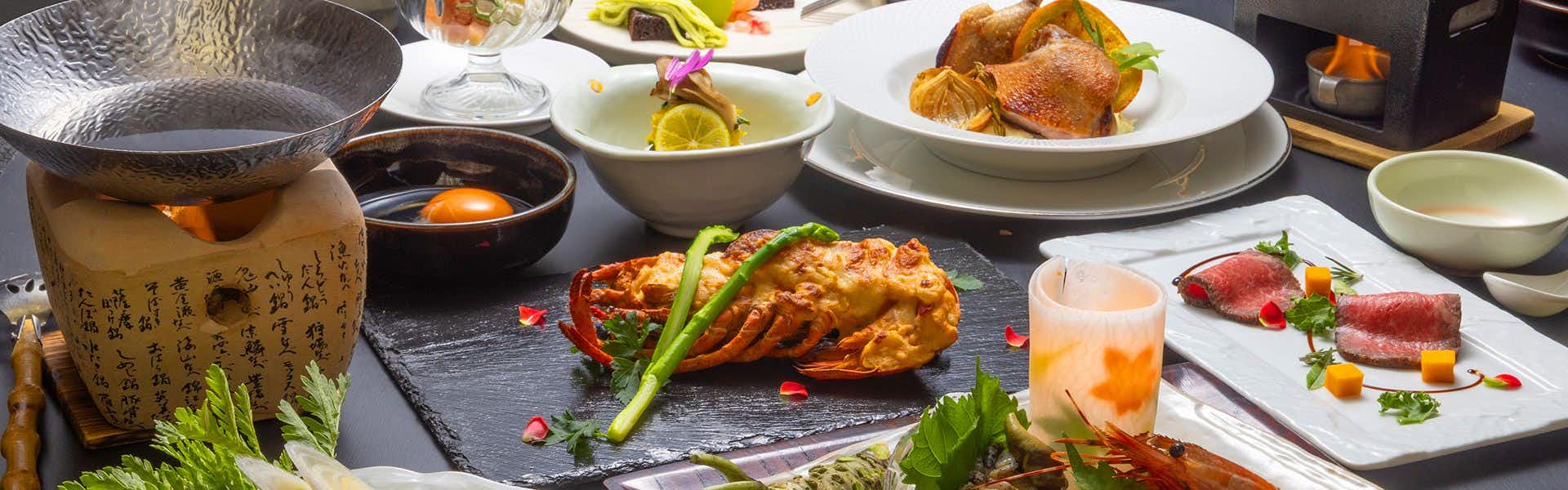 Saikatei Jidaiya with a generous Japanese dinner arranged across colorful ceramic dishes.