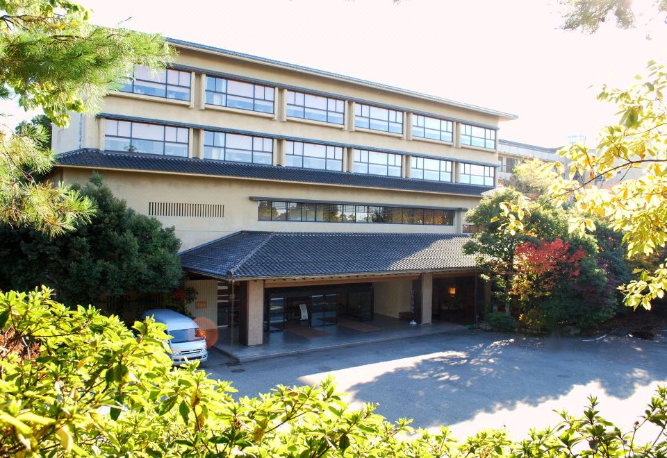 The ryokan facade among trees.