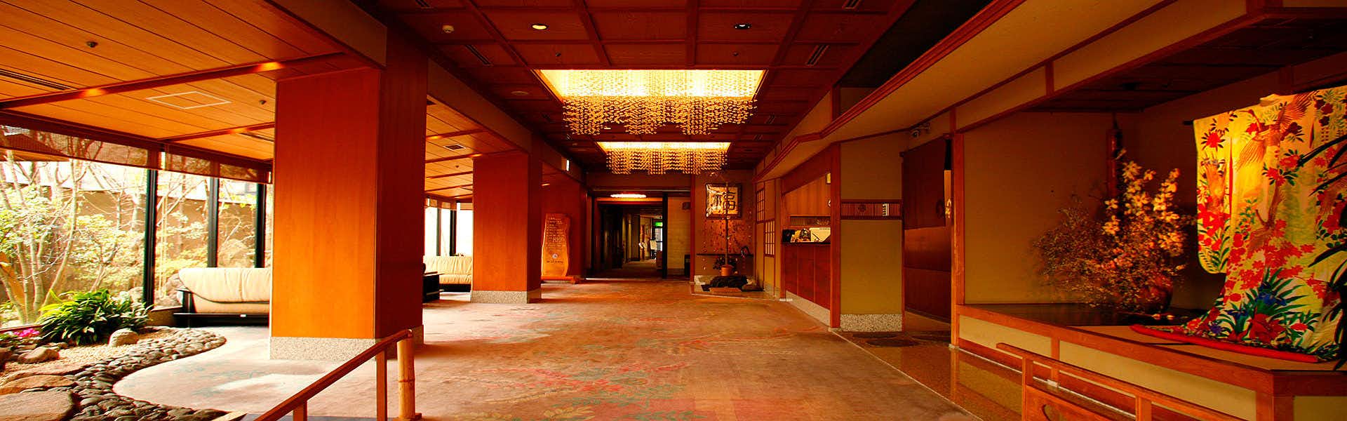 Toi Fujiya Hotel with a grand lobby corridor with red walls and floral artwork.