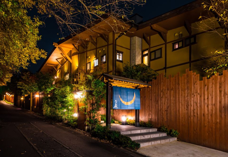A ryokan building with illuminated windows.