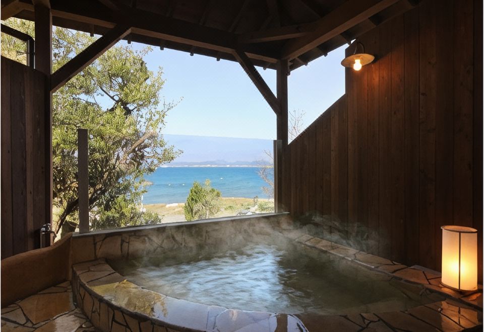 A covered outdoor bath overlooking the sea.