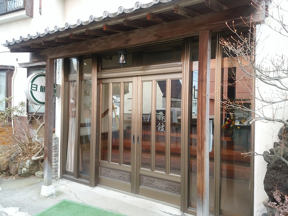 The ryokan entrance with sliding glass doors.