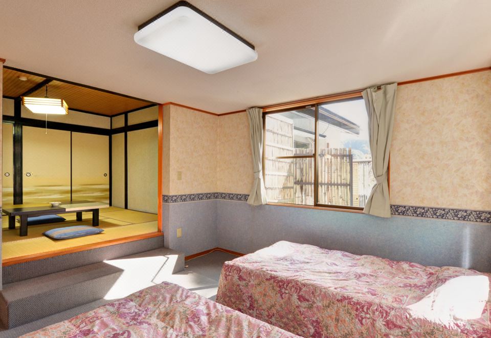 Twin beds beside an adjoining tatami sitting room.