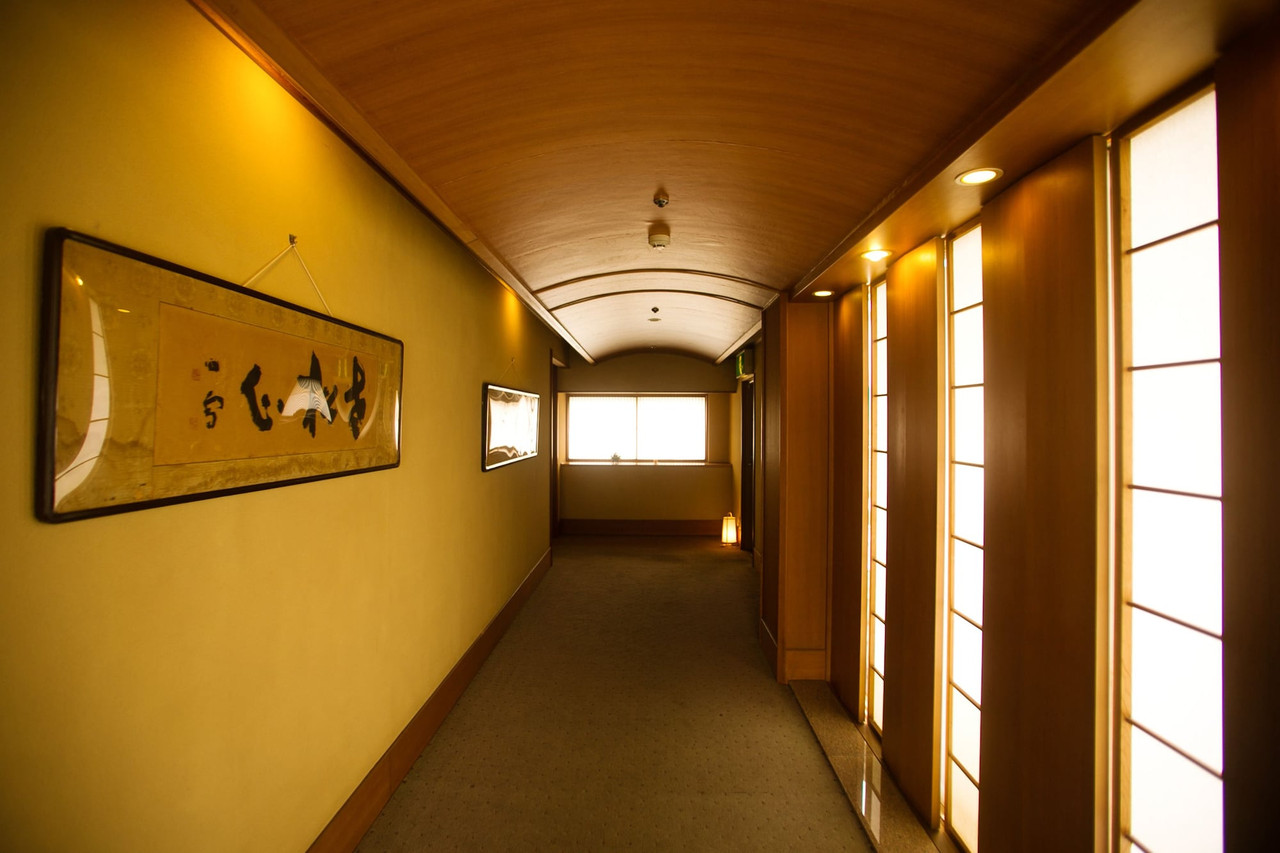 Wood-lined corridor with shoji screens.