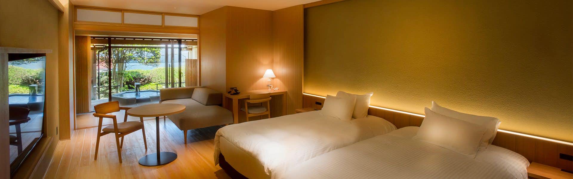 Hotel Kitanoya with a modern bedroom opening toward calm bay views.