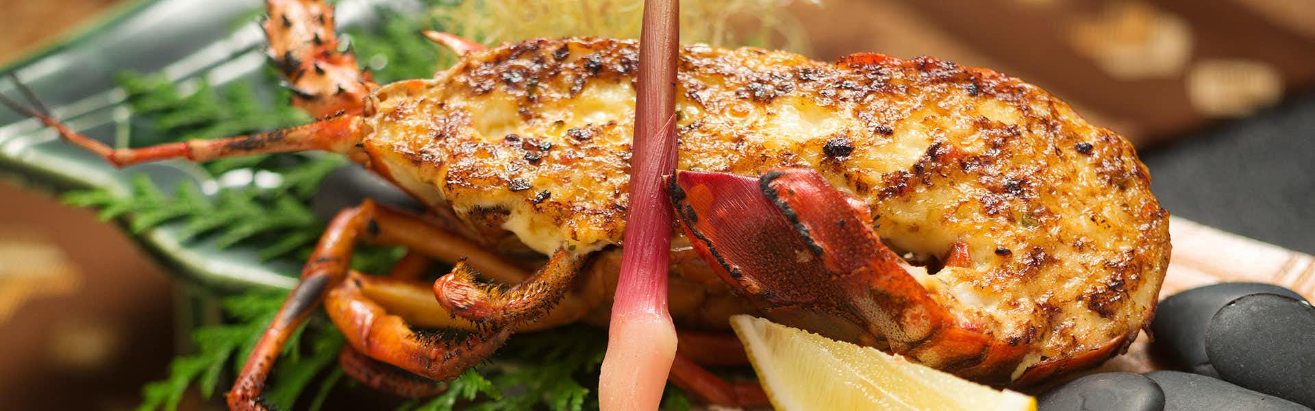 Ryokan Kotobukitei grilled lobster with browned surface on a plate