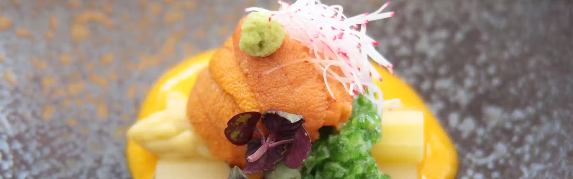 Ryotei Ryokan Atami Koarashitei with this scene, where a plated course pairs seafood with a bright yellow sauce and shredded garnish.
