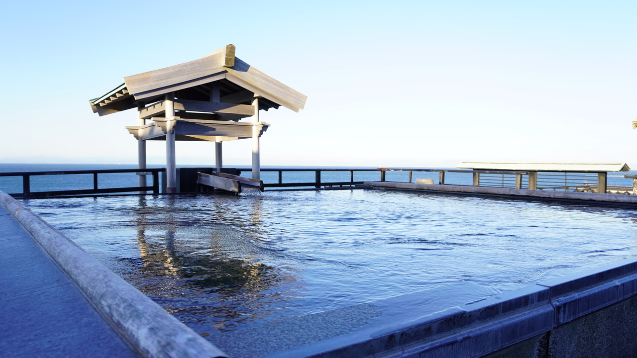 Covered outdoor bath with a sea view.