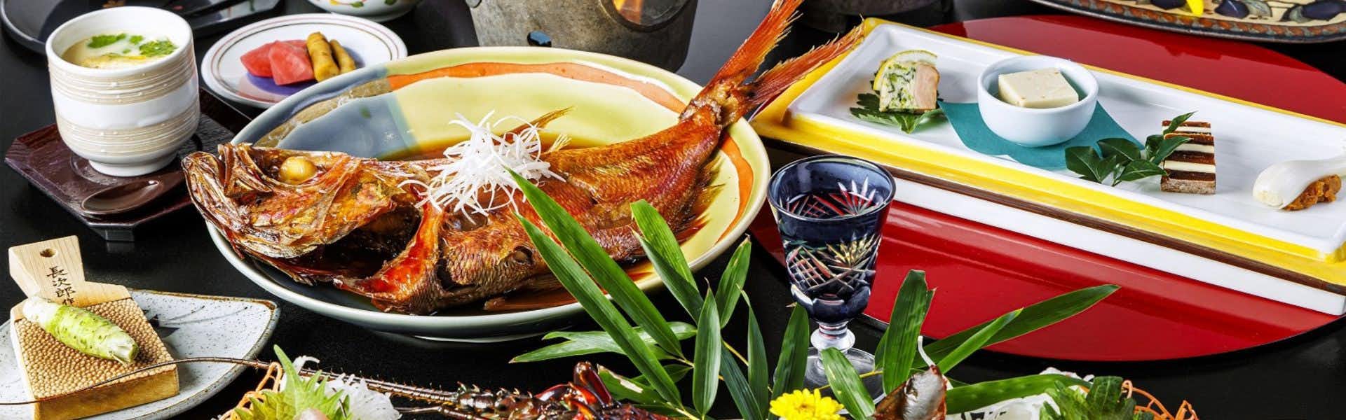 Izu Atagawa Onsen: A Journey Through Six Private Baths - Yuhana Mankai, A Retreat for Two large glazed dish surrounded by colorful small plates