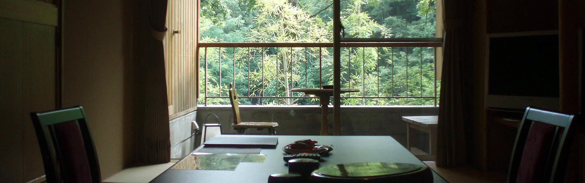 Wado Onsen Yuno Yado Wado with a quiet dining room overlooking dense forest greenery.