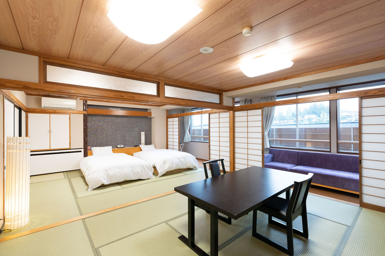 Guest room with beds and a low table.